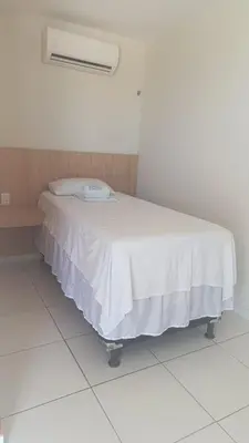 Uma cama ou camas num quarto em Pousada Use Sabor Caseiro