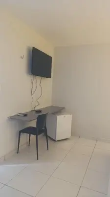 Uma televisão e/ou sistema de entretenimento em Pousada Use Sabor Caseiro