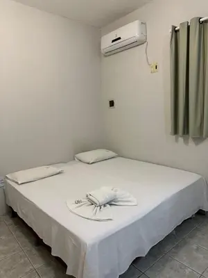 Uma cama ou camas num quarto em Residencial Dumont