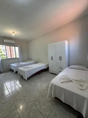 Uma cama ou camas num quarto em Residencial Dumont