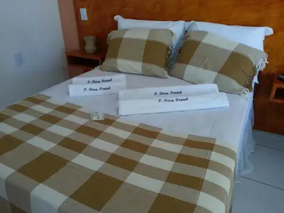 Uma cama ou camas num quarto em Pousada Brisa Do Pontal