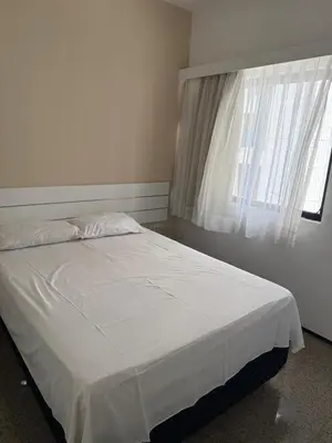 Uma cama ou camas num quarto em Villa Costeira Flat