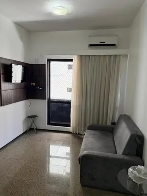 Uma área de estar em Villa Costeira Flat