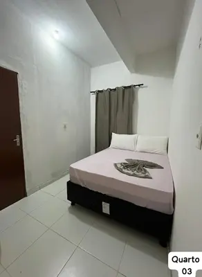 Uma cama ou camas num quarto em Casa Fundo de Quintal