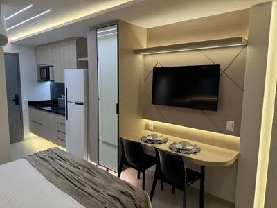 Uma televisão e/ou sistema de entretenimento em Flat Beach Class 600m from the beach Fortaleza praia