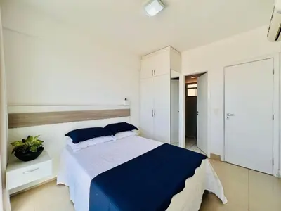 Uma cama ou camas num quarto em Super Apartamento Palm Beach