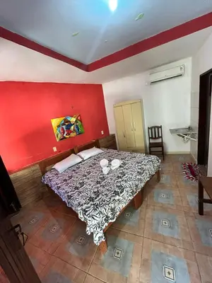 Uma cama ou camas num quarto em Pousada Rosa Mistica