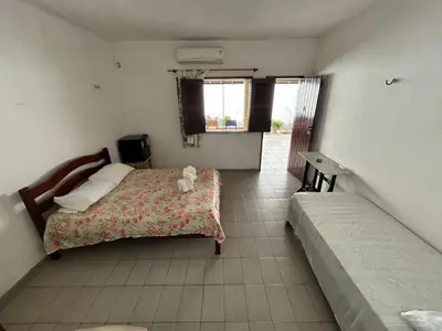 Uma cama ou camas num quarto em Pousada Rosa Mistica