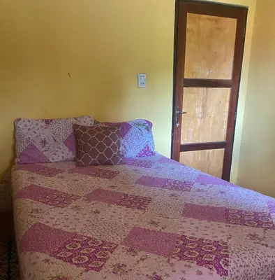 Uma cama ou camas num quarto em Casa da Helô