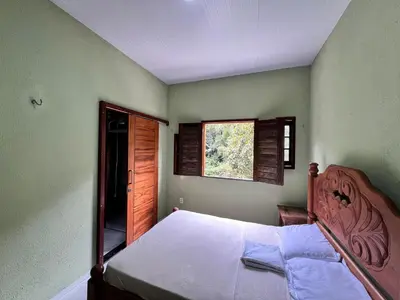 Uma cama ou camas num quarto em Casa em Guaramiranga há apenas 5 minutos das cachoeiras