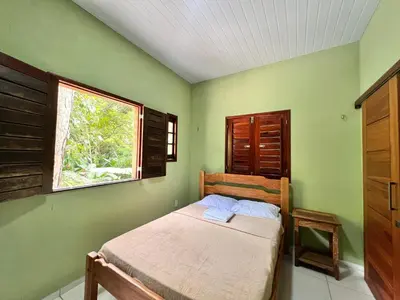 Uma cama ou camas num quarto em Casa em Guaramiranga há apenas 5 minutos das cachoeiras