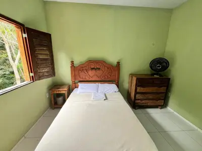 Uma cama ou camas num quarto em Casa em Guaramiranga há apenas 5 minutos das cachoeiras