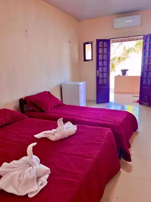 Uma cama ou camas num quarto em Pousada Brisa Mineira