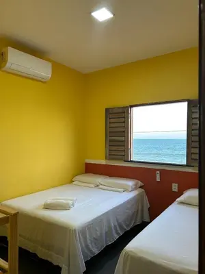 Uma cama ou camas num quarto em Chalé brisa do mar
