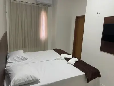 Uma cama ou camas num quarto em Hotel complexo paris
