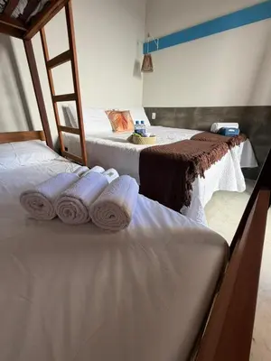 Uma cama ou camas num quarto em Pousada Villa Santorini Preá
