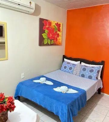 Uma cama ou camas num quarto em Pousada Novo Amanhecer