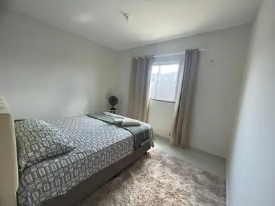 Uma cama ou camas num quarto em Casa para acomodar sua família e amigos