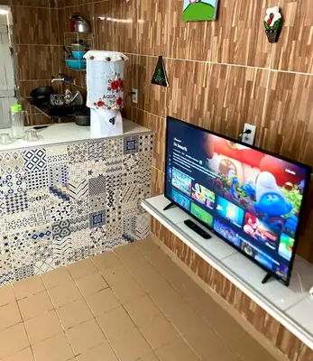 Uma televisão e/ou sistema de entretenimento em Green House Cumbuco