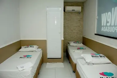 Uma cama ou camas num quarto em Pousada Moda New