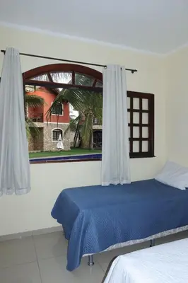Uma cama ou camas num quarto em Chalé em Condomínio com