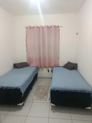 Uma cama ou camas num quarto em Rogerio AP Compartilhado