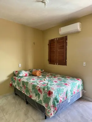 Uma cama ou camas num quarto em Pousada encantos de morro branco