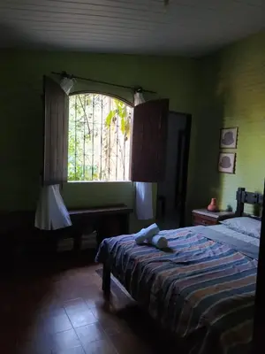 Uma cama ou camas num quarto em Casa belíssima alto da serra guaramiranga