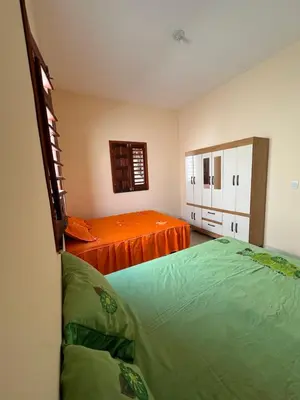 Uma cama ou camas num quarto em Casa Amarela no Fortim