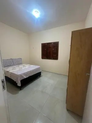Uma cama ou camas num quarto em Casa Amarela no Fortim