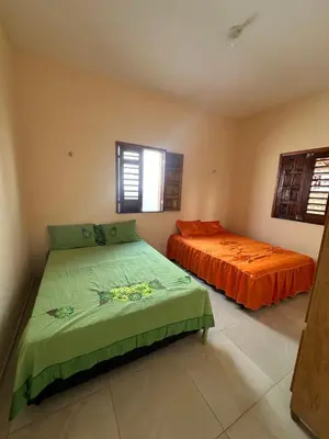 Uma cama ou camas num quarto em Casa Amarela no Fortim