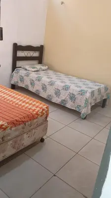 Uma cama ou camas num quarto em Retorno às Raízes Casa de Praia