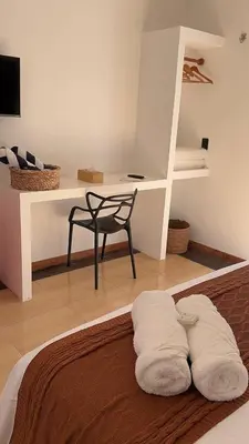 Uma cama ou camas num quarto em Suítes House Refúgio Fortim