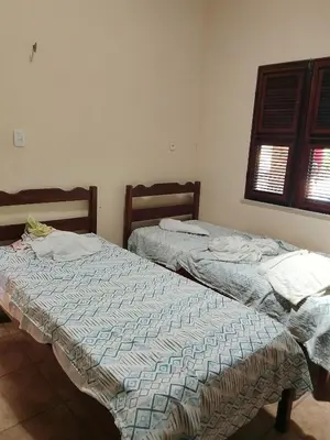 Uma cama ou camas num quarto em Casa do cajueiro