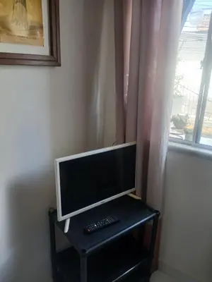 Uma televisão e/ou sistema de entretenimento em Quarto Aconchegante
