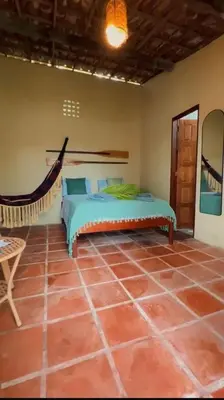 Uma cama ou camas num quarto em Vila Manguita Suite kiwwi