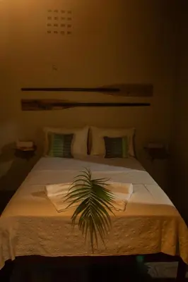 Uma cama ou camas num quarto em Vila Manguita Suite kiwwi
