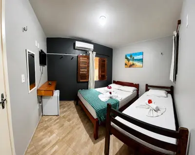 Uma cama ou camas num quarto em Pousada Anauá Jericoacoara