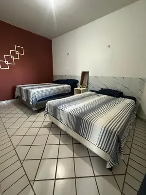 Uma cama ou camas num quarto em Condomínio Porto Canoa
