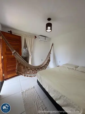 Uma cama ou camas num quarto em Suites Fernandes Fortim