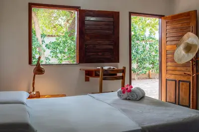 Uma cama ou camas num quarto em Pousada Flambaião