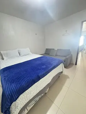Uma cama ou camas num quarto em Casa com Suíte e Ar Condicionado 200mts da praia