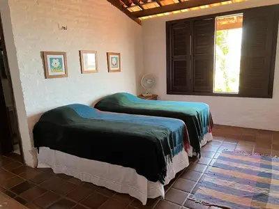 Uma cama ou camas num quarto em Casa incrível com vista para o mar - próximo ao beach park