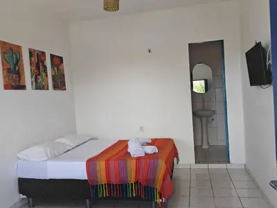Uma cama ou camas num quarto em Casa Jambo Canoa Quebrada