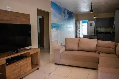 Uma televisão e/ou sistema de entretenimento em Sítio Helena - Casa de praia