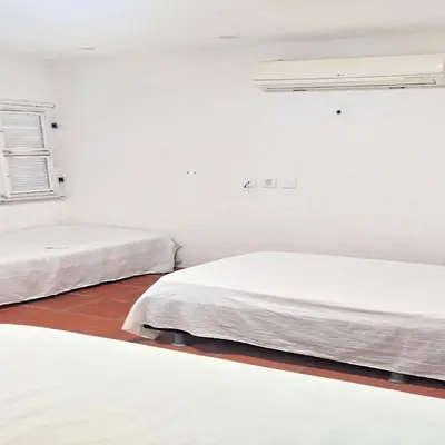 Uma cama ou camas num quarto em Pousada Refúgio Praia & Café