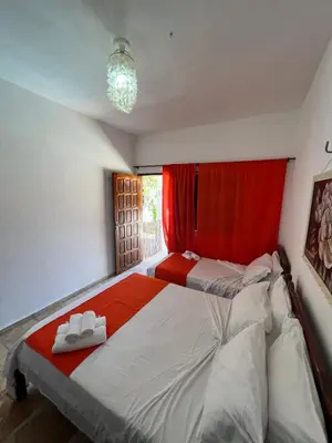 Uma cama ou camas num quarto em Pousada Califórnia Tia Lia