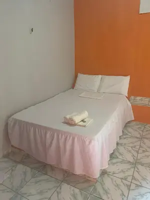 Uma cama ou camas num quarto em Pousada Sol Dourado