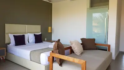 Uma cama ou camas num quarto em Ravenala Hotel Boutique