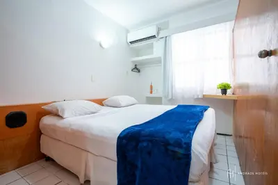 Uma cama ou camas num quarto em Rede Andrade Coimbra